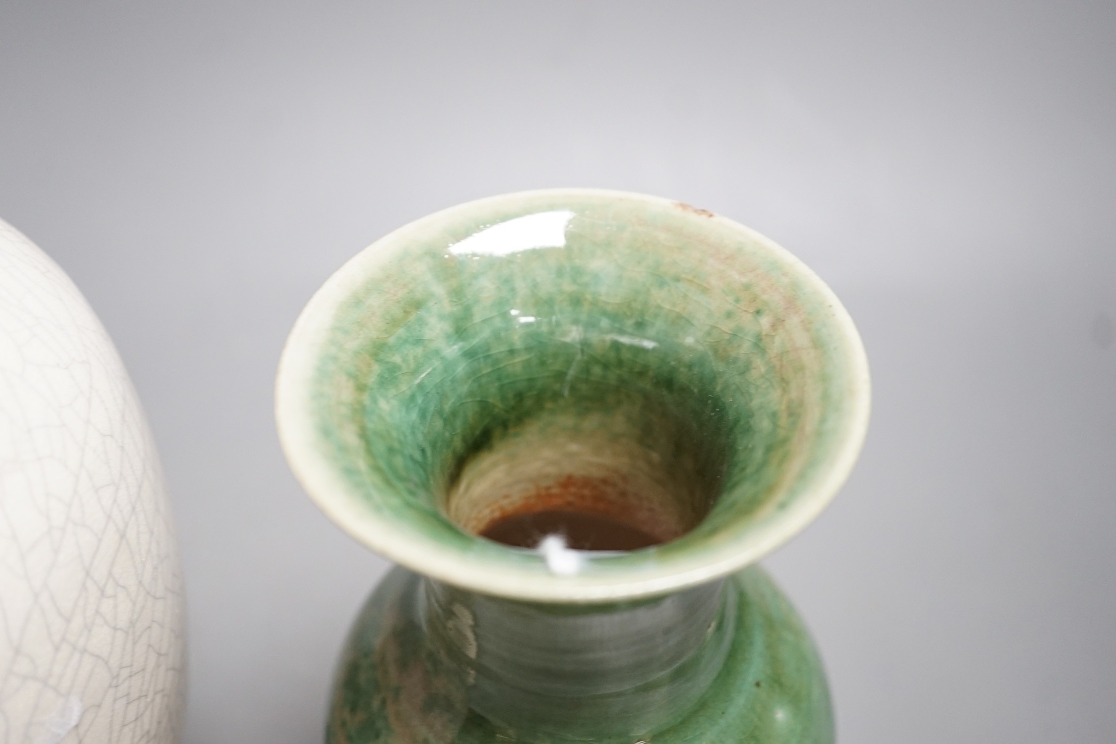 A Chinese white crackleware vase and a smaller green glazed vase